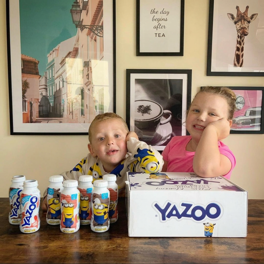 Two children posing with a Yazoo Minions milk drinks seeding box and bottles
